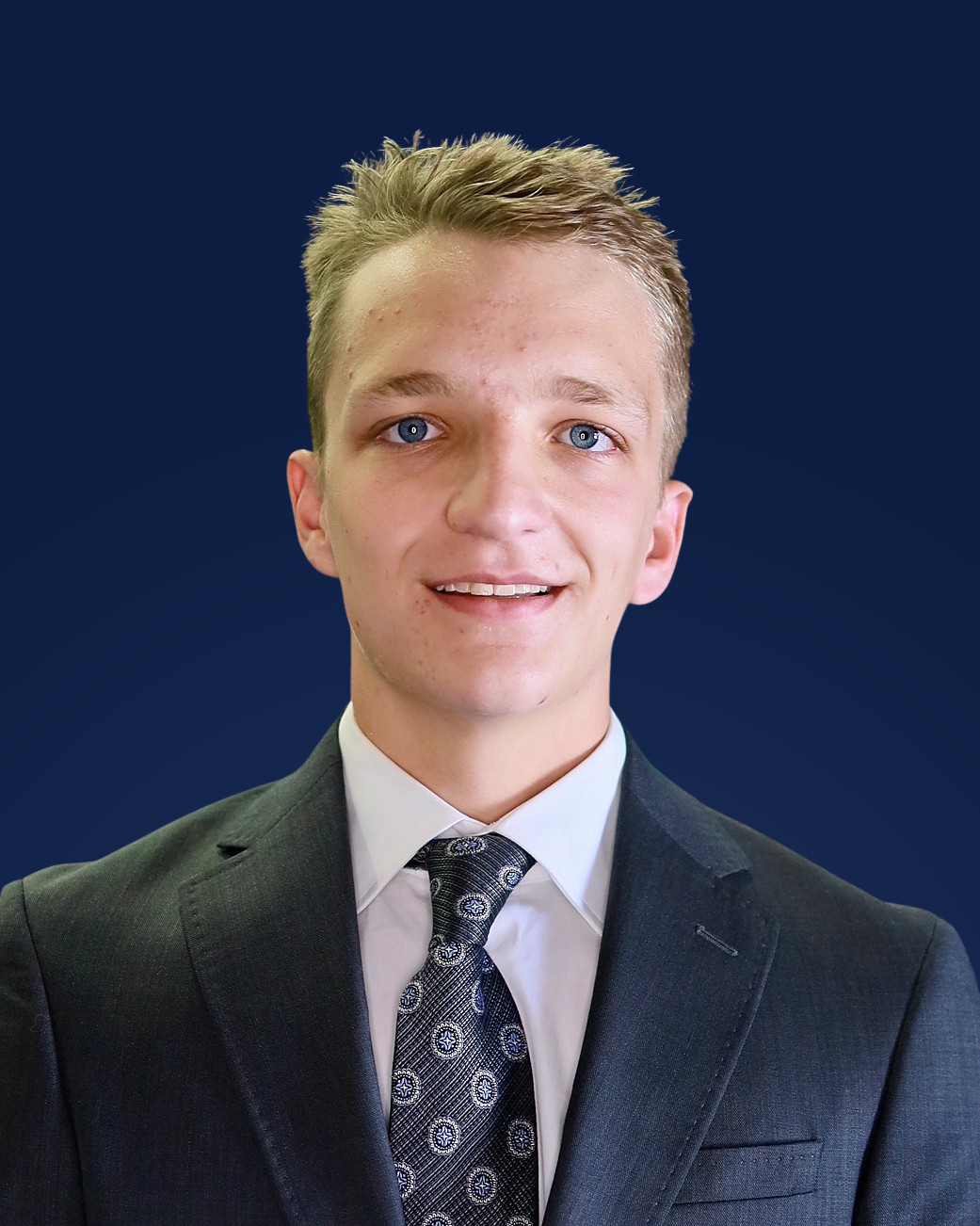 Matthew Liss wearing a suit and tie